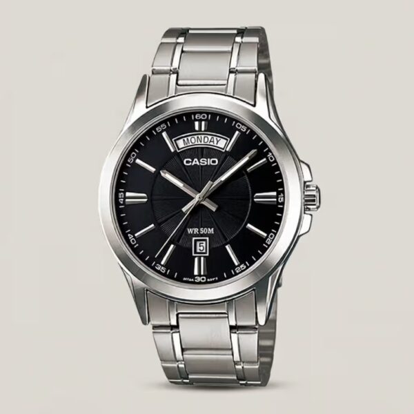 Casio MTP-1381D-1A stainless steel analog watch featuring a black dial with wide-format day display and date window, plus 50-meter water resistance.