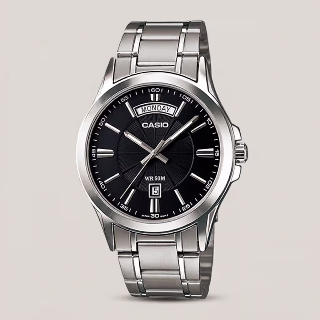 Casio MTP-1381D-1A stainless steel analog watch featuring a black dial with wide-format day display and date window, plus 50-meter water resistance.