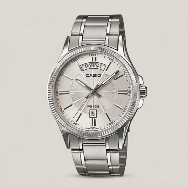 Casio MTP-1381D-7A stainless steel analog watch featuring a silver white dial with wide-format day and date display, plus 50-meter water resistance.