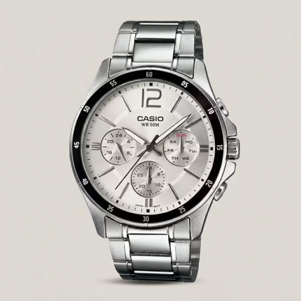 Casio MTP-1374D-7A analog stainless steel watch with silver-white dial, triple subdials for day, date, and 24-hour time, and 50-meter water resistance.