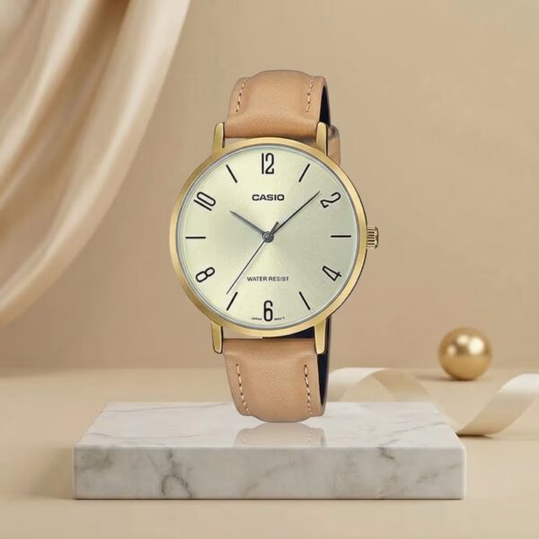 Casio ladies champagne dial watch with gold-tone case and tan leather strap