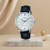 Casio ladies white dial watch with blue hands and hour markers, silver-tone case and black leather strap