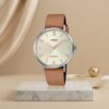 Casio ladies champagne dial watch with silver-tone case, tan leather strap and rose-gold hands and markers