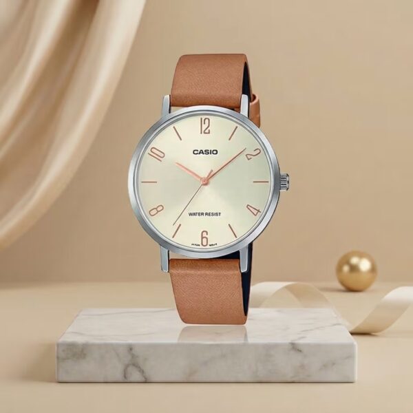 Casio ladies champagne dial watch with silver-tone case, tan leather strap and rose-gold hands and markers