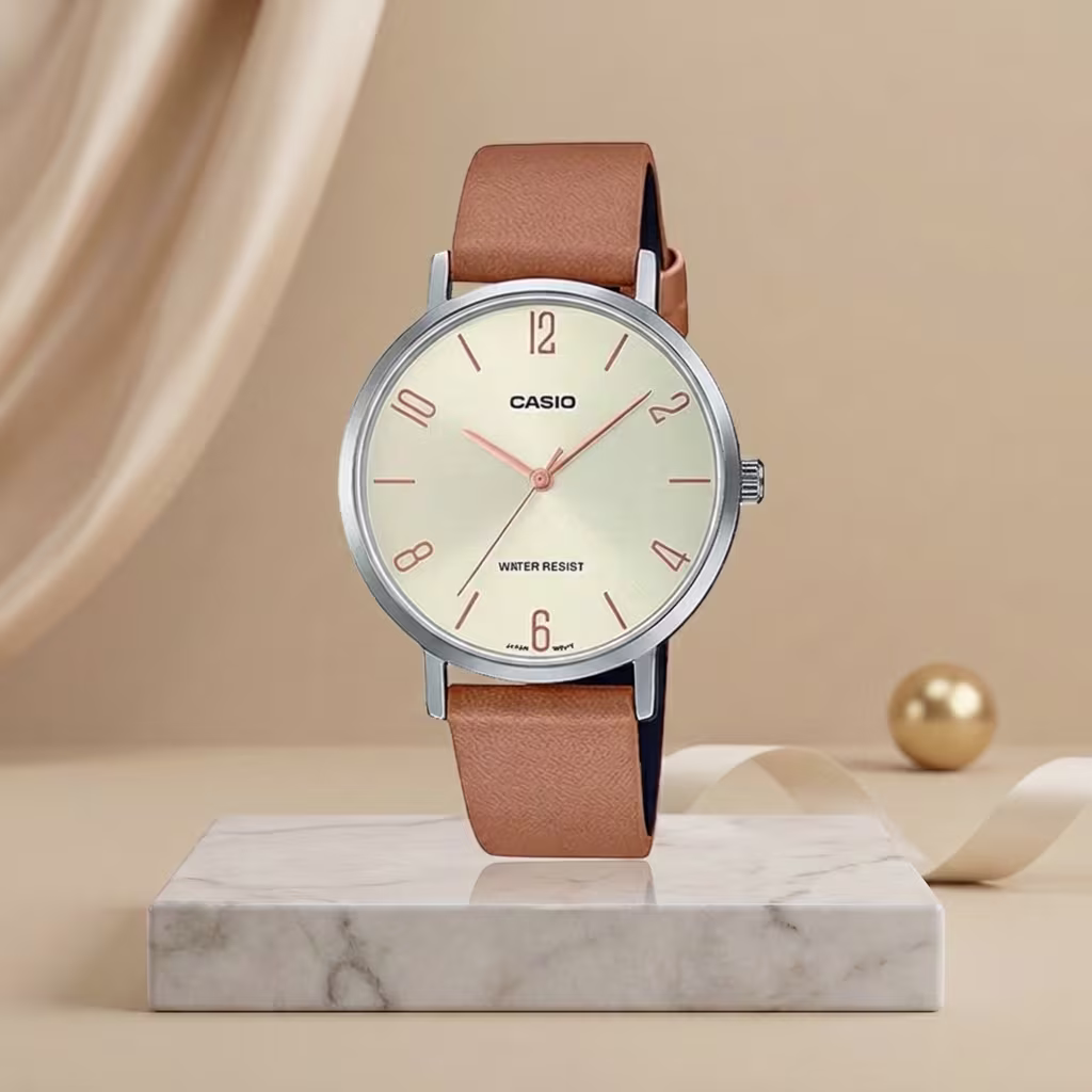 Casio ladies champagne dial watch with silver-tone case, tan leather strap and rose-gold hands and markers