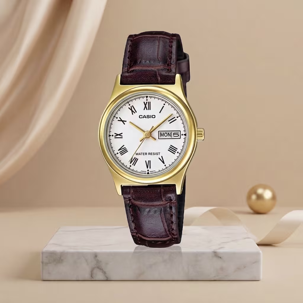 Casio ladies gold-tone watch with white Roman numeral dial, brown leather strap and day-date display