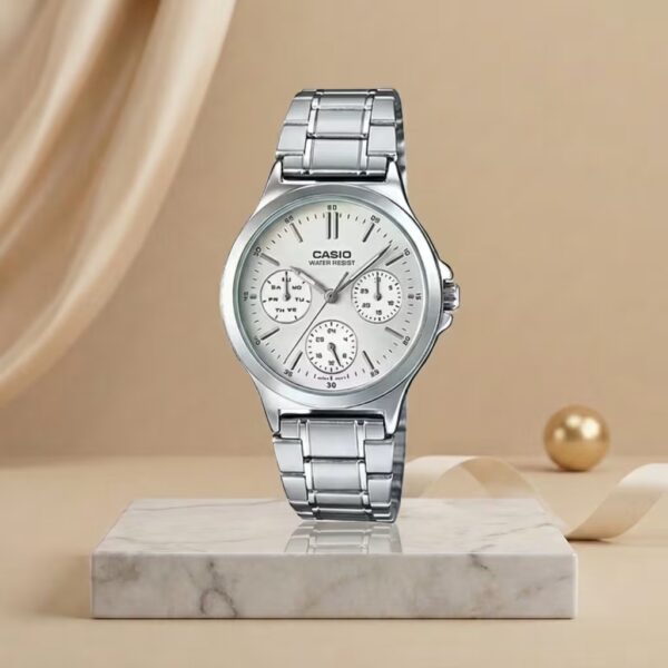 Casio women’s silver multi-dial watch displayed on a marble stand