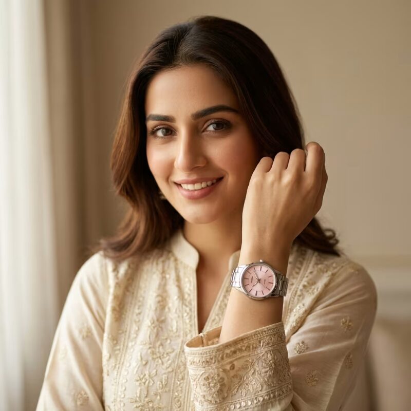 Woman wearing pink dial analog wrist watch