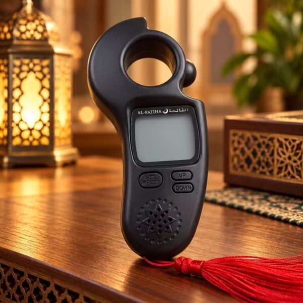 Al-Fatiha digital Tasbeeh counter in matte black with Azan reminder, LCD display, clock and red tassel.