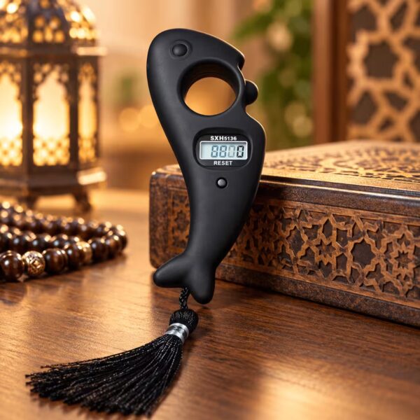 Matte black fish-shaped digital Tasbeeh counter with LCD display, finger grip and black tassel