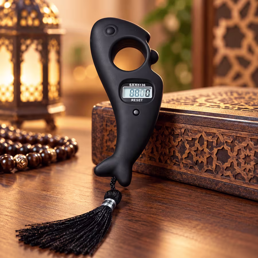 Matte black fish-shaped digital Tasbeeh counter with LCD display, finger grip and black tassel