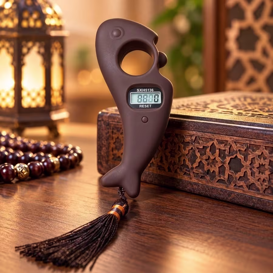 Matte brown fish-shaped electronic Tasbeeh counter with LCD screen, finger grip and decorative tassel